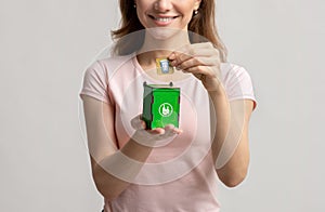 Waste Sorting. Woman Putting Card With Drinking Glass Into Small Garbage Container
