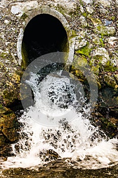Waste water flowing out of a sewage pipe