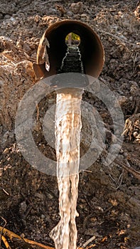 Waste water flows from the pipe,pollution of nature and the environment,industrial mud.