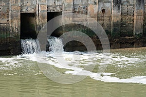 waste water flows from a pipe, Sewage pipe polluting water