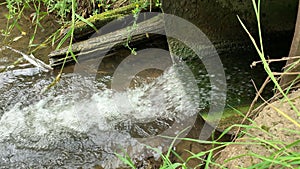 Waste water,mud flows from the pipe into the river,environmental pollution,the environment is contaminated