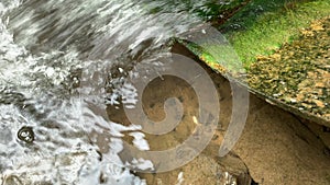 Waste water,mud flows from the pipe into the river,environmental pollution,the environment is contaminated