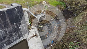 Waste water, pollution and garbage in urban canal.