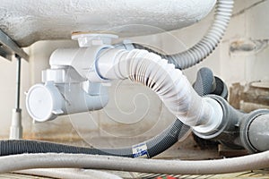 Waste water siphon or sink drain connected to the bottom of the acrylic tub. Installation, cleaning and repair of household plumbi