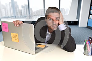 Wasted businessman working in stress at office laptop computer looking exhausted