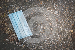 Wasted medical mask on the pavement in the street, copy space