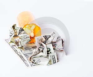 Wasted money on Prescription Drugs reflected with crumbled up money