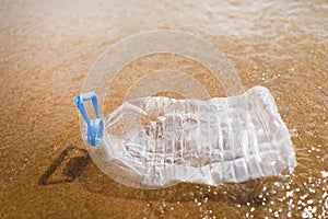 Wasted plastic bottle on beach photo