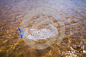 Wasted plastic bottle on beach photo