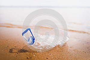 Wasted plastic bottle on beach photo