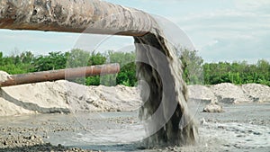 Wastewater from Large Rust Pipe Merge into Environment on the background of the Forest. Sewage from the Sewer Pollutes Terrain.