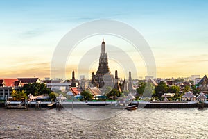 Wat Arun and Chao Phraya River with beautiful sunset sky background, Bangkok, Thailand