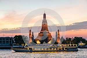 Wat Arun and cruise ship in night ,Bangkok city ,Thailand