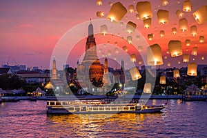 Wat arun and cruise ship in night time and floating lamp in yee peng festival under loy krathong day, Bangkok city ,Thailand