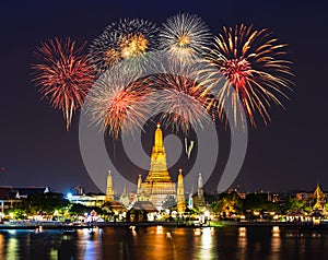 Wat Arun with fireworks celebration at night in Bangkok, Thailand