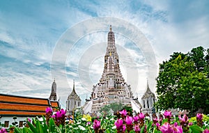 Wat Arun Ratchawararam with beautiful blue sky and white clouds. Wat Arun buddhist temple is the landmark in Bangkok, Thailand.