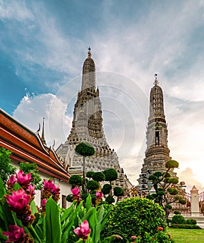 Wat Arun Ratchawararam with beautiful blue sky and white clouds. Wat Arun buddhist temple is the landmark in Bangkok, Thailand.