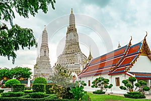 Wat Arun Ratchawararam with beautiful blue sky and white clouds. Wat Arun buddhist temple is the landmark in Bangkok, Thailand.