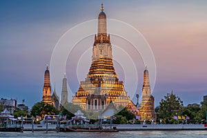 Wat Arun stupa, a significant landmark of Bangkok, Thailand, stands prominently along the Chao Phraya River, with a beautiful