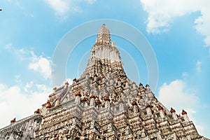 Wat Arun Temple of dawn the famous beautiful landmark in Bangkok Thailand. Wat Arun temple in a blue sky. Wat Arun is a Buddhist