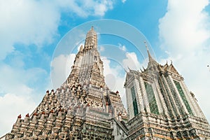 Wat Arun Temple of dawn the famous beautiful landmark in Bangkok Thailand. Wat Arun temple in a blue sky. Wat Arun is a Buddhist