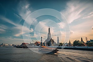 Wat Arun at sunset with long tail boat, in Bangkok, Thailand. Generative AI