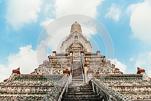 Wat Arun Temple of dawn the famous beautiful landmark in Bangkok Thailand. Wat Arun temple in a blue sky. Wat Arun is a Buddhist