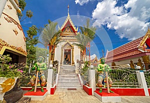 Wat Buddhist temple in Phuket Town Thailand. Decorated in colours of Gold Brown and White. Sunset Sunrise lovely sky