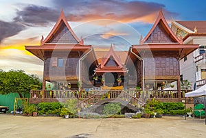 Wat Buddhist temple in Phuket Town Thailand. Decorated in colours of Gold Brown and White. Sunset Sunrise lovely sky