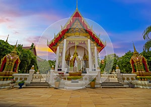 Wat Buddhist temple in Phuket Town Thailand. Decorated in colours of Gold Brown and White. Sunset Sunrise lovely sky