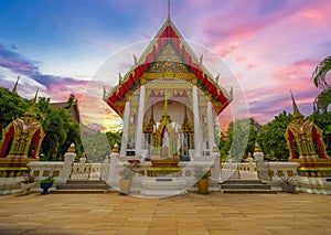 Wat Buddhist temple in Phuket Town Thailand. Decorated in colours of Gold Brown and White. Sunset Sunrise lovely sky