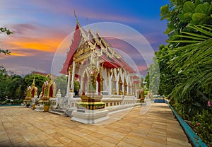 Wat Buddhist temple in Phuket Town Thailand. Decorated in colours of Gold Brown and White. Sunset Sunrise lovely sky