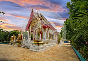 Wat Buddhist temple in Phuket Town Thailand. Decorated in colours of Gold Brown and White. Sunset Sunrise lovely sky