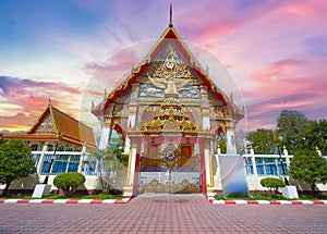 Wat Buddhist temple in Phuket Town Thailand. Decorated in colours of Gold Brown and White. Sunset Sunrise lovely sky