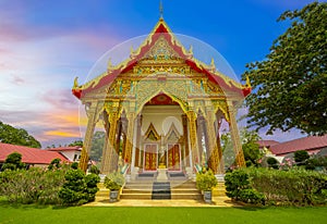 Wat Buddhist temple in Phuket Town Thailand. Decorated in colours of Gold Brown and White. Sunset Sunrise lovely sky