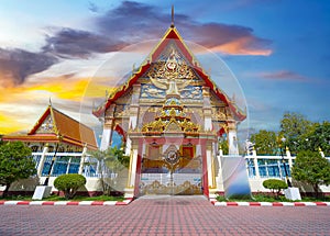 Wat Buddhist temple in Phuket Town Thailand. Decorated in colours of Gold Brown and White. Sunset Sunrise lovely sky