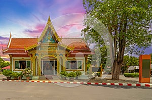 Wat Buddhist temple in Phuket Town Thailand. Decorated in colours of Gold Brown and White. Sunset Sunrise lovely sky