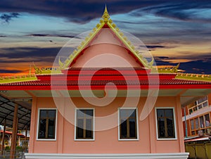 Wat Buddhist temples in Phuket Thailand. Decorated in beautiful ornate colours of red and Gold and Blue. Lovely sunset
