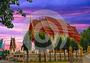 Wat Buddhist temples in Phuket Thailand. Decorated in beautiful ornate colours of red and Gold and Blue. Lovely sunset