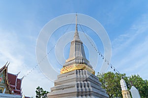 Wat Chantharam Worawihan or Wat Klang Talat Phlu, a Buddhist temple stupa at noon with blue sky in Bangkok city, Thailand. Thai