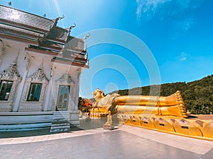 Wat Khao Sung Chaem Fa temple with giant snake and reclining gold buddha, in Kanchanaburi, Thailand