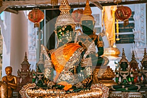 Wat Khao Sung Chaem Fa temple with giant snake and reclining gold buddha, in Kanchanaburi, Thailand