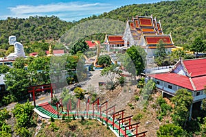 Wat Khao Sung Chaem Fa temple with giant snake and reclining gold buddha, in Kanchanaburi, Thailand