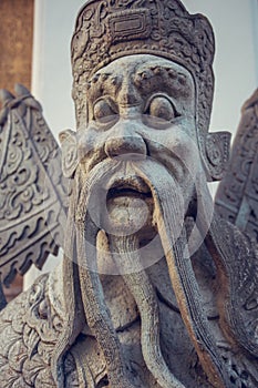 Wat Pho stone guardian statue. Bangkok, Thailand.