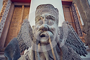 Wat Pho stone guardian statue. Bangkok, Thailand.