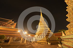 Wat Phra Chetuphon or Wat Pho, a Buddhist temple illuminated at night in Bangkok City, Thailand. Thai architecture buildings