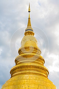 Wat Phra That Hariphunchai Pagoda with cloud at Lamphun,Thailand