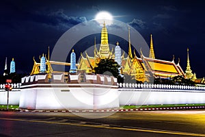 Wat phra keaw with full moon at night in Bangkok.