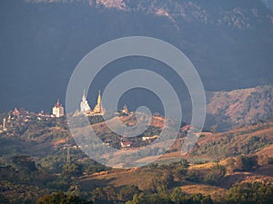 Wat Phra That Pha Son Kaew from a Distance , Next to a Mountain Range