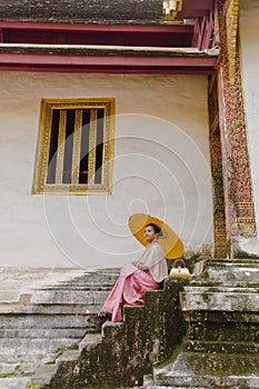 Wat Phra Singh historic landmark of in Chiang Mai Thailand with south asian relaxing woman